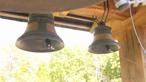 Traditional rustic church bronze bells hanging. 