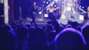 Close up of recording video with smartphone during a concert