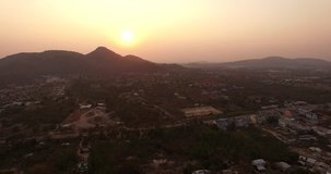 4k aerial video, bird eye view, drone fly over thai temple on mountain in sunset.