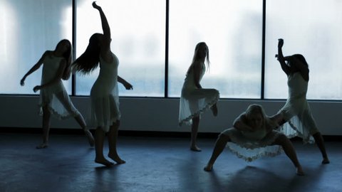 Caucasian African American girls children teenagers indoors silhouette barefoot dance studio perform movement freedom interpretation