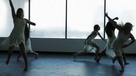 young multi ethnic girls children teenagers dance dancing school indoors window silhouette dress barefoot ballerina training