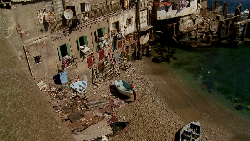 High angled long shot of building and shoreline