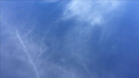 Blue sky with high level light cirrus cloud formation, zooming in, hand held. 