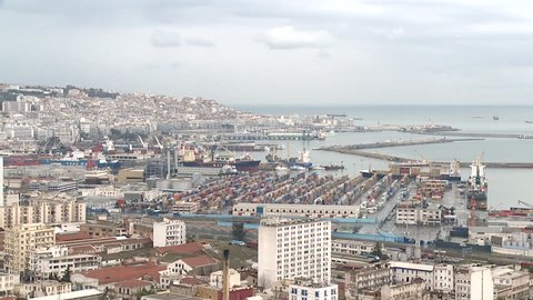 Panning long shot of Algiers cityscape and harbour