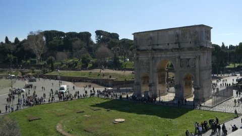 ROME, ITALY / OCTOBER 3RD 2015: Roman Coliseum colosseum on summer day with blue sky. Famous Italian landmark travel icon in the Roman forum  tourists and visitors arch of triumph