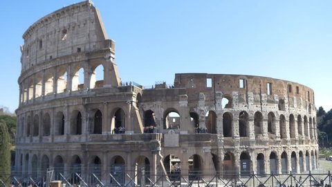 ROME, ITALY / OCTOBER 3RD 2015: Roman Coliseum colosseum on summer day with blue sky. Famous Italian landmark travel icon in the Roman forum with tourists and visitors
