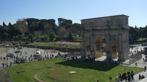 ROME, ITALY / OCTOBER 3RD 2015: Roman Coliseum colosseum on summer day with blue sky. Famous Italian landmark travel icon in the Roman forum time lapse timelapse  tourists and visitors arch of triumph