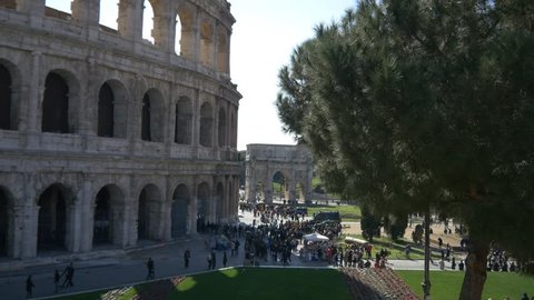 ROME, ITALY / OCTOBER 3RD 2015: Roman Coliseum colosseum on summer day with blue sky. Famous Italian landmark travel icon in the Roman forum with tourists and visitors