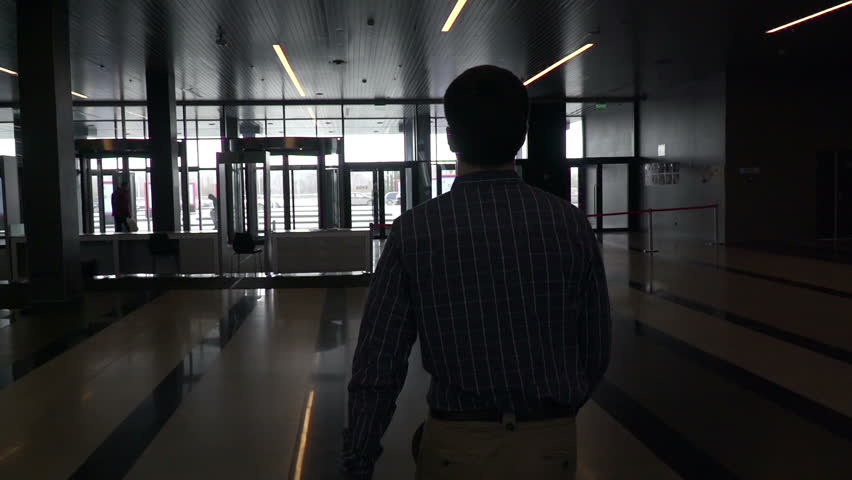 One man in shirt goes to an important economic activity. Human walks in shopping center or modern mall for conference or meeting. Close up indoors. Portrait of guy. Men and white collar. Slow motion