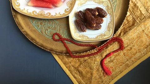 Arabian dates, fresh fruits and Islamic rosary. A healthy food for braking fast during holy month of Ramadan. Top panning shot video stock clip.