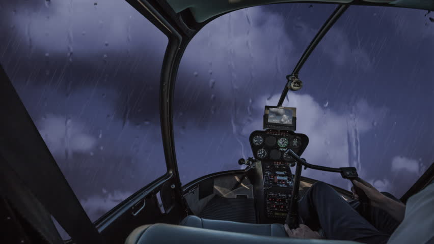 Helicopter cockpit flying in a stormy cloudy sky with rain and thunders | Shutterstock HD Video #15884965