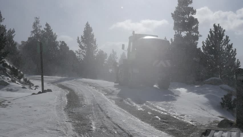Falling snow in a winter park with snow covered trees white cover on mountain wild top high winds and frozen rivers 4k snowfall christmas misty scene beautiful magical scenery storm