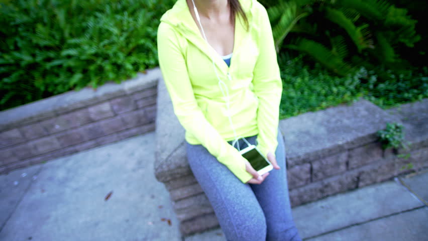 young Hispanic USA girl exercise lifestyle active sport clothing video diary selfie outdoor city smart phone wireless technology