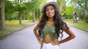 portrait POV walking sassy personality smiling young ethnic Asian Indian girl retro clothing hat summer video diary