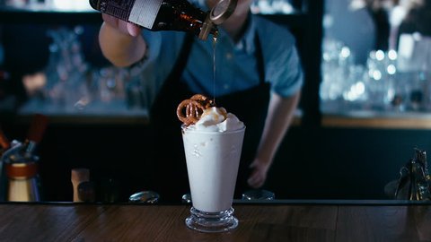 Barista adding syrup to a milk shake. 4K cinemagraph - motion photo seamless loop