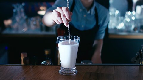 Barista stirring a milkshake. 4K cinemagraph - motion photo seamless loop