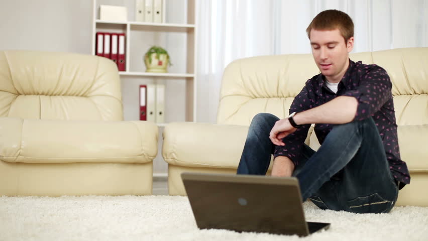 Guy with laptop on carpet. DOLLY HD 
