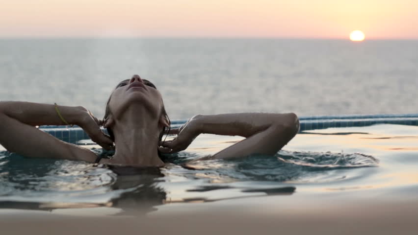 Luxury resort woman relaxing in infinity pool Royalty-Free Stock Footage #15910837