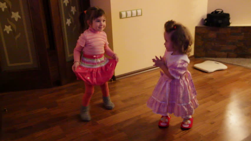 two little girls dancing at home