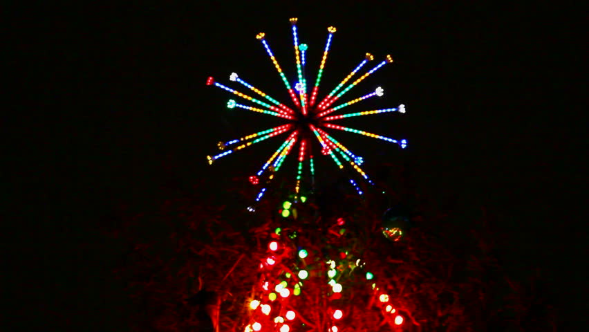 top of christmas fir with colored lightings