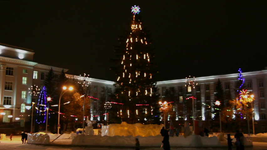 christmas fir on town square at night - timelapse
