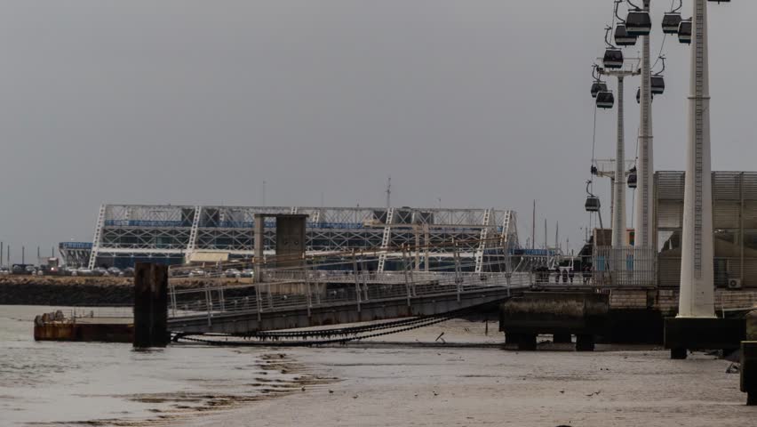 Timelapse 4k: ropeway near Vasco da Gama Tower, is a 145 m lattice tower with skyscraper in Lisbon, Portugal, built over Tagus river, named after explorer, who was to arrive in India by sail, in 1498