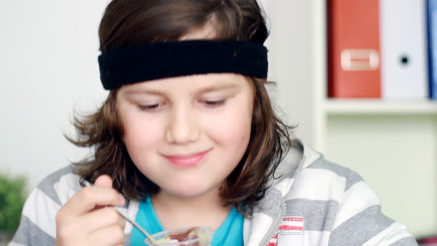 Boy eating dessert and smiling, camera stabilizer shot