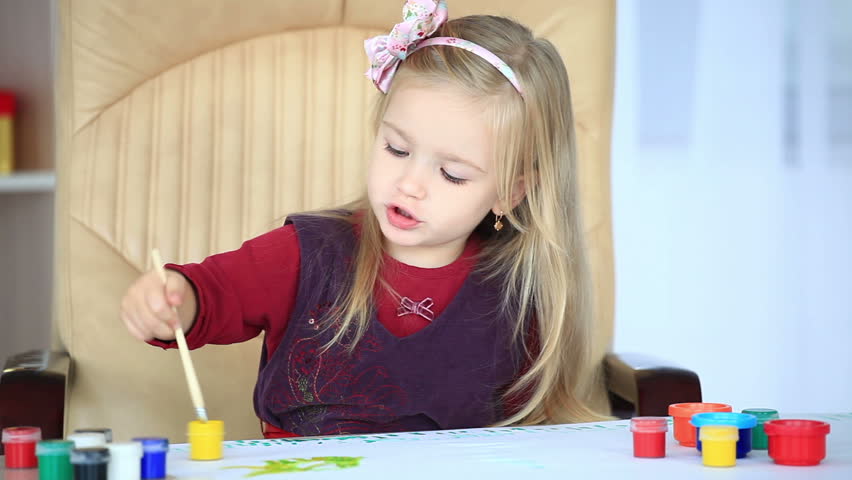 Girl learns to paint with a brush-1 