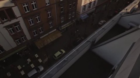 Parkour Runner does long run over rooftaop in frankfurt germany.