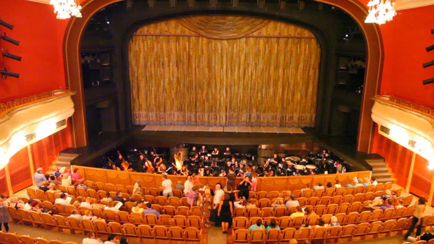 In big theatre many people take places for viewing