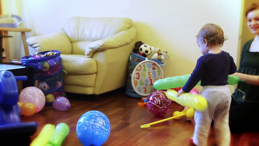 Mother and little boy playing with balloons