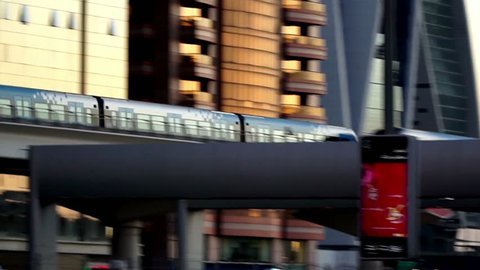 Dubai, UAE-Jan 28,2016: A metro train passing before the modern buildings in Dubai, UAE
