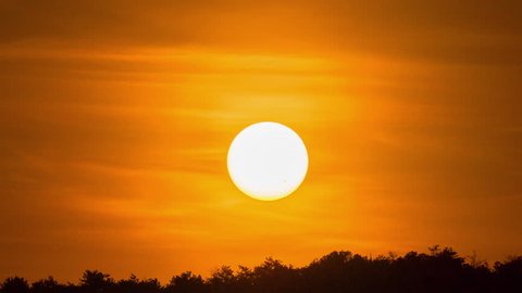 Sunset sunrise sun timelapse. Beautiful dawn nature landscape. Sky time lapse background. Orange yellow clouds, sun silhouette. Bright evening scenic sunset sunlight. Colorful dusk, big huge hot sun. 