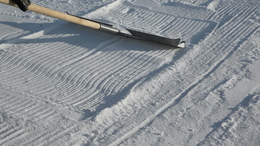 snowboarder shovel build a kicker. close up