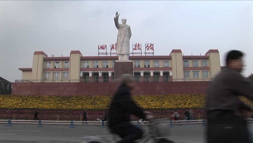 A statue of Chinese leader and revolutionary Mao is in the distance