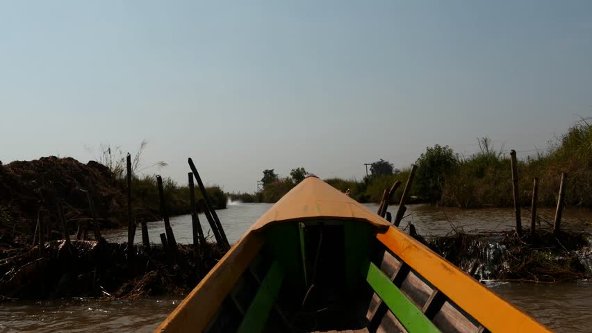 March 3 2016 Nyaungshwe, Myanmar. View from running motor boat running through narrow passages. Around Inle Lake there are many small villages which connect to the main lake by means of narrow canals
