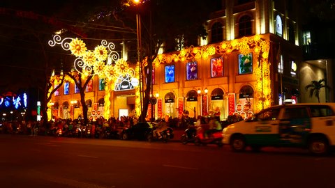 HO CHI MINH CITY, VIETNAM - MARCH 22, 2016: View of the busy night life as pedestrians and traffic pass by the street on March 22, 2016 in Ho Chi Minh City, Vietnam.
