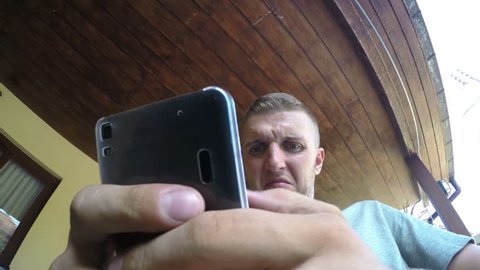 Closeup Crazy Funny Man Texting on Smart Phone. 4K.