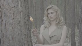 Blonde woman in the forest looking to escape 