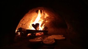 video footage of a stone stove with fire to make pizza in a restaurant in Cusco, Peru. South America