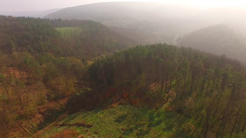 Aerial flight down green mountain forest and river 