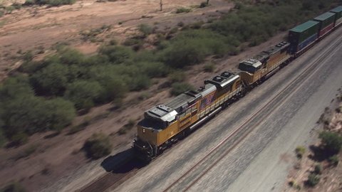 AERIAL: Long container freight train transporting goods across the country