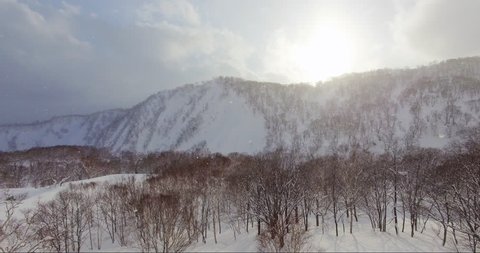 Aerial View of Orange Light Sunrise in Japanese Mountains - Niseko, Hokkaido, Japan