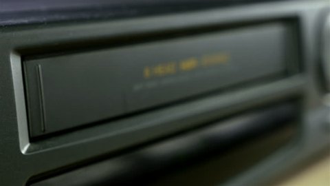 Inserting a VHS Tape into a VCR Player