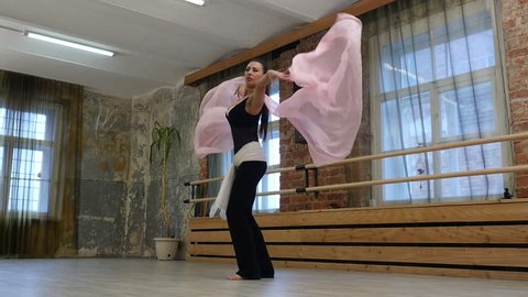 Beautiful young brunette woman practicing belly dance in a dance studio, Full HD shot