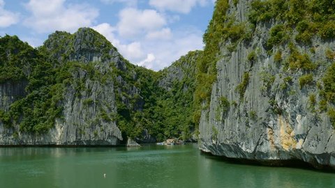 fly along impressive carst limestone cliffs of ha long bay Vietnam, UNESCO World Heritage Site, Spectacular Vietnamese Islands, Beautiful Landscape Marine, Water Scene, 4k, ultra high definition