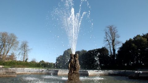 Fontain water splash against the blue sky in castle park - Kilkenny castle, Ireland