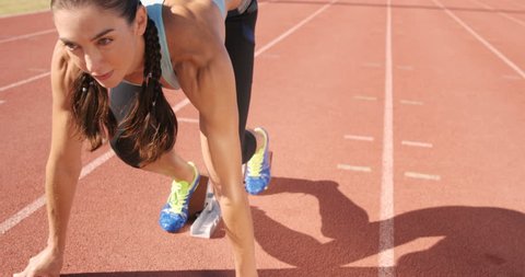 Athlete woman starting running on running track Stock Video