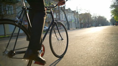 male employee goes to work by bicycle in the morning slow motion