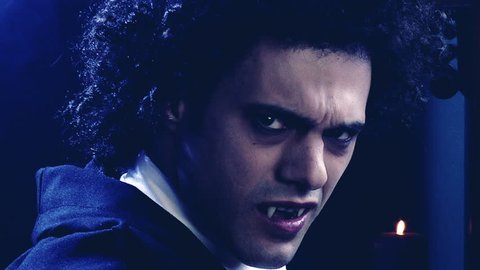 Sad male vampire turning around looking camera angry slow motion dolly shot 
